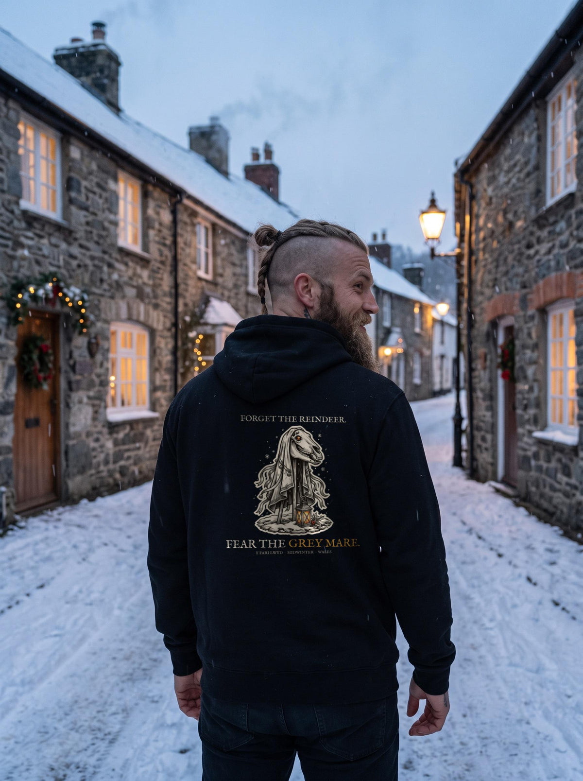 Mari Lwyd hoodie worn in a winter scene, showing the big back print